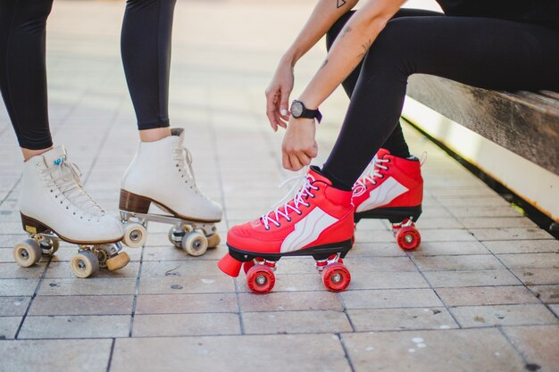 Image of two individuals wearing roller skates with the camera focusing on their feet